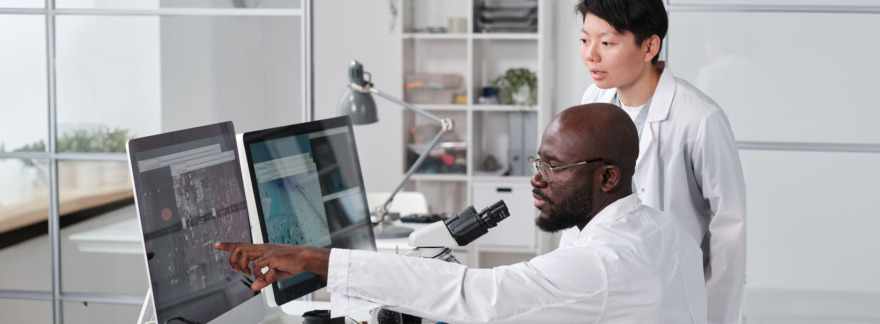 Scientists in laboratory coats Looking at scans