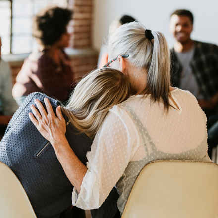 Support group consoling hug