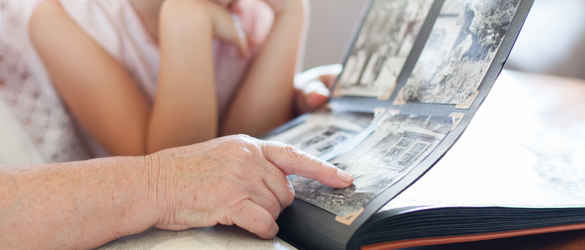 Grandmother and granddaughter looking through photo album