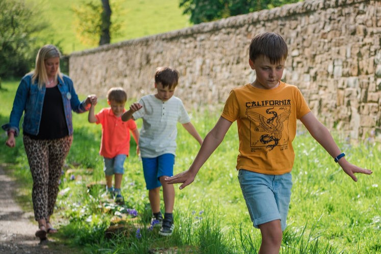 Kelly and her sons walking on stones
