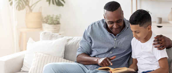 Man and boy reading together