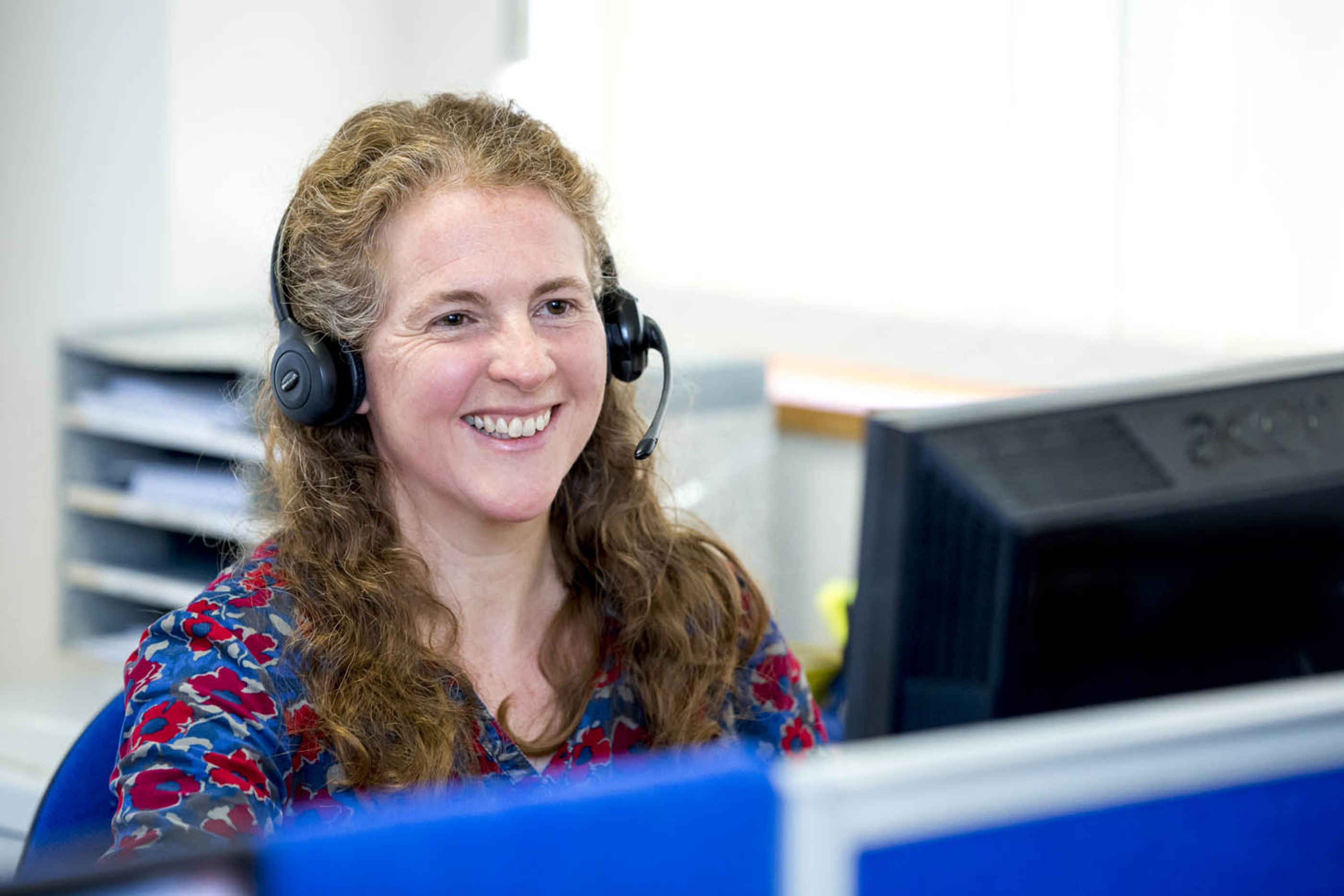 staff member on phone smiling