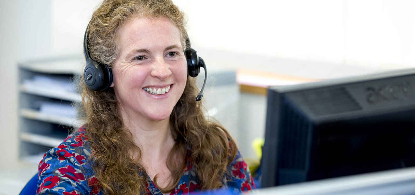 staff member on phone smiling