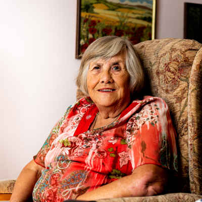 Pat Hayes smiling in armchair