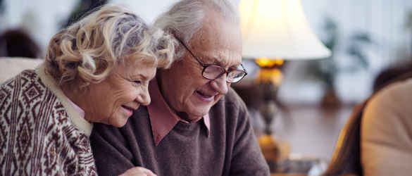 Elderly couple looking at a tablet