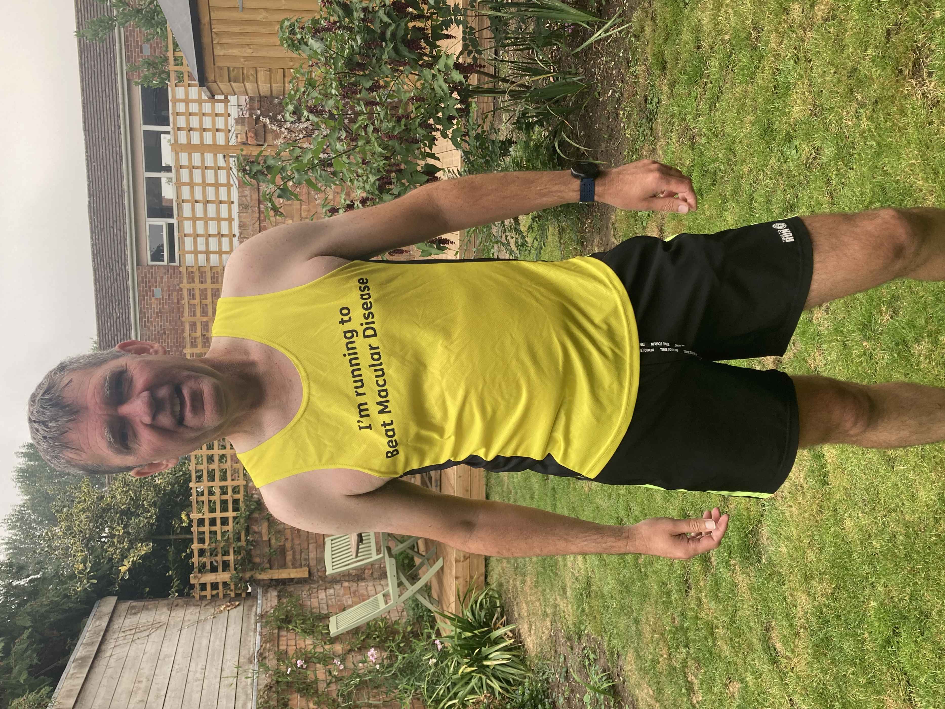 James in Macular Society t-shirt in garden 