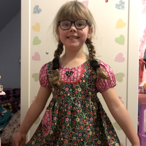 Matilda smiling showing off her cute dress