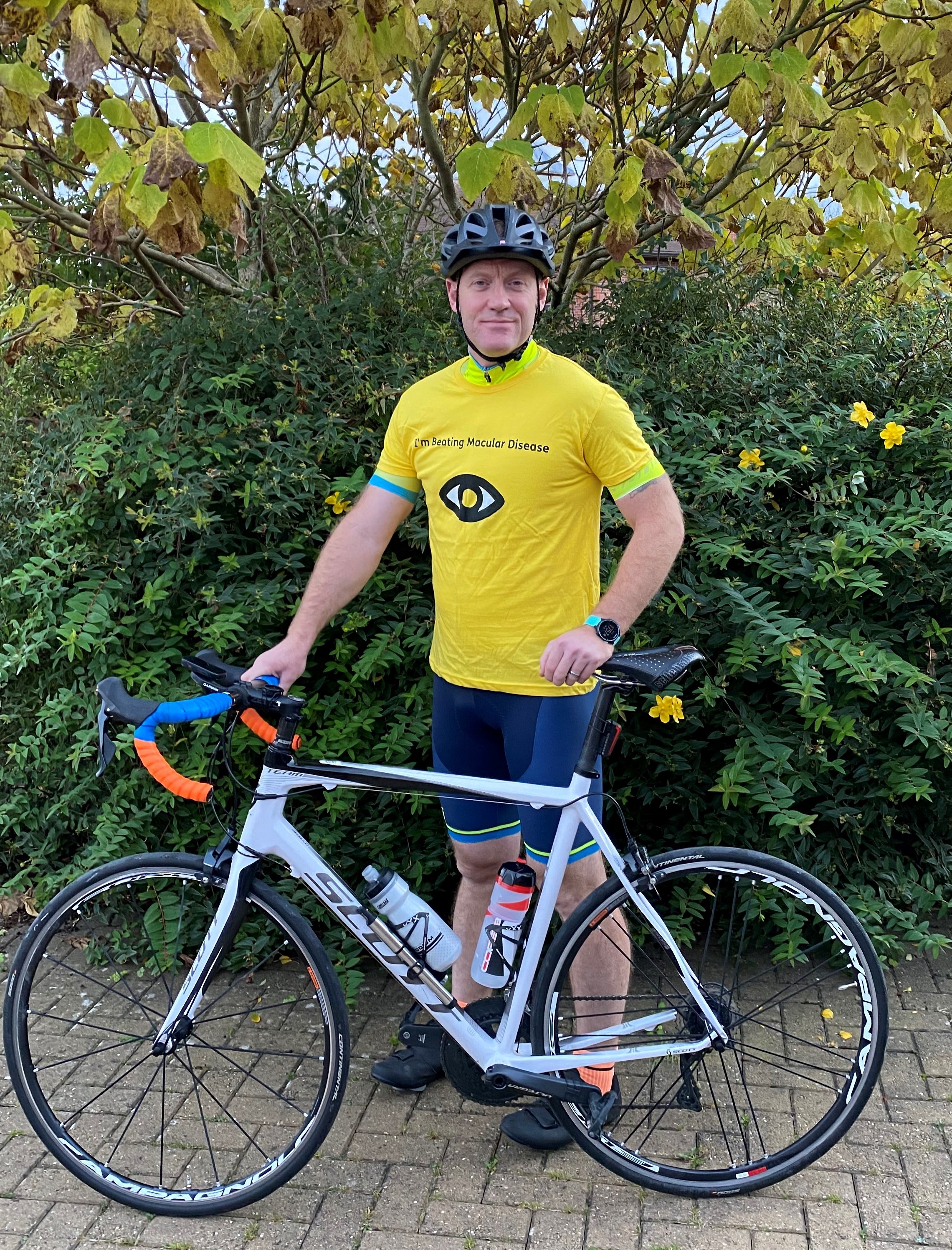 Simon Jones in Macular Society top, with cycle.