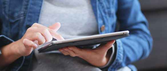 Individual reading a tablet